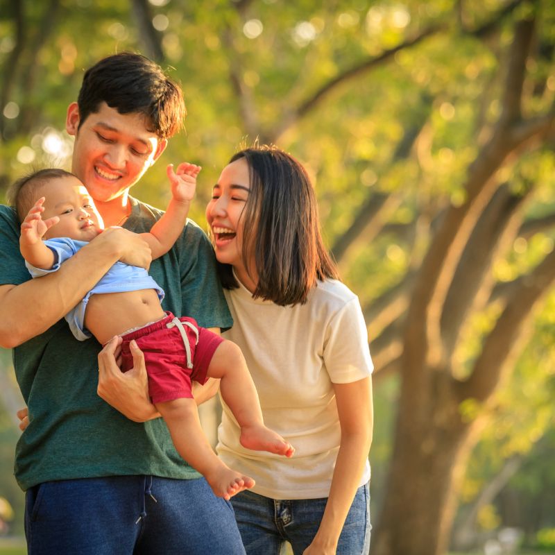 Family embracing representing term and whole life insurance security
